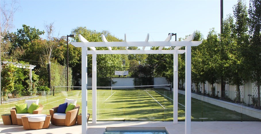 Renovated pool and tennis court in Melbourne, with new sandstone paving laid in a diamond pattern to be in keeping with the property.  Pergola added over the spa area to match existing structure.  Pool fencing changed from steel panels to frameless glass. contemporary pool designs and landscaping, pool plants landscaping, swimming pool landscaping, contemporary pool designs and landscaping.