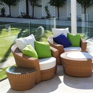 Contemporary outdoor furniture in landscaped setting. 