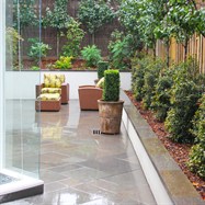 Rear garden excavated to accommodate large rear courtyard, paved with random rectangular paving.  All gardens retained with rendered block walls and capped with bluestone.  Formal hedging planted to hide fence lines.